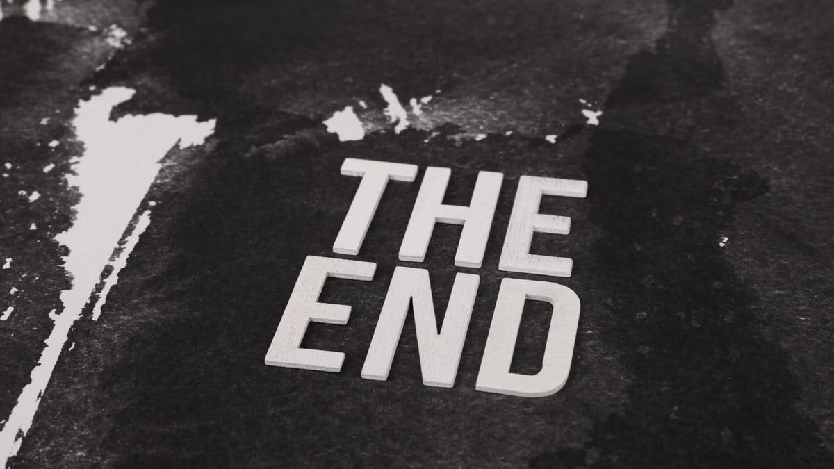 Close-up of the phrase 'The End' in white text on a dark, textured background.